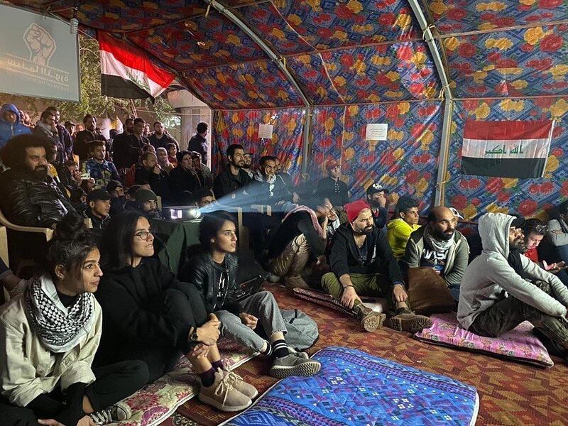 People attend a screening at the Cinema of the Revolution tent in Tahrir Square, Baghdad, Iraq. Photo courtesy of Mohanad Hayal