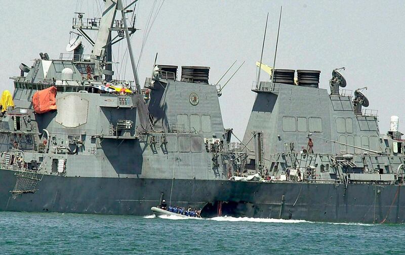 FILE - In this Oct. 15, 2000 file photo, experts in a speed boat examine the damaged hull of the USS Cole at the Yemeni port of Aden after an al-Qaida attack that killed 17 sailors. The Supreme Court on Tuesday threw out a nearly $315 million judgment against Sudan stemming from the USS Cole bombing, saying Sudan hadnâ€™t properly been notified of the lawsuit. (AP Photo/Dimitri Messinis, File)