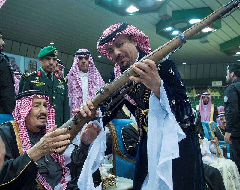 King Salman of Saudi Arabia check out a gun at the Janadriyah cultural festival in Riyadh on February 20, 2018. Bandar Algaloud / Courtesy of Saudi Royal Court / Reuters