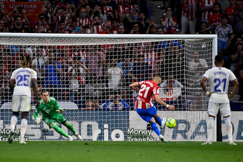 Atletico Madrid's Yannick Carrasco scores from the penalty spot. AFP