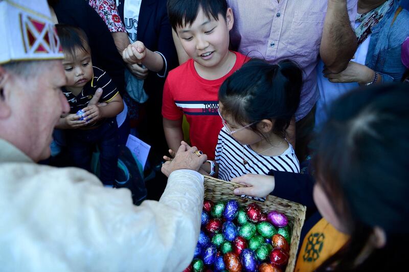 Archbishop Anthony Fisher hands out Easter eggs after Easter Sunday Solemn Mass at St Mary's Cathedral in Sydney, Australia. EPA