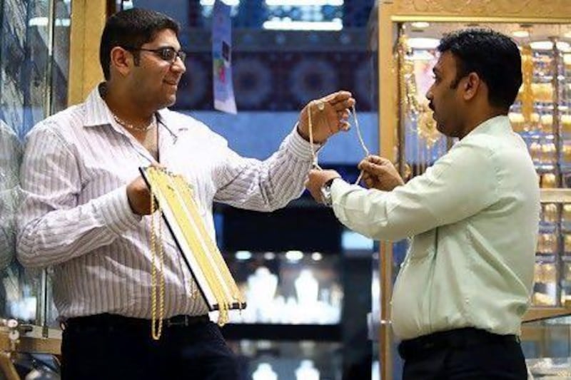 Krish Kumar, left, the business development manager at Kiran Jewellers, will launch his business selling car parts this year. Satish Kumar / The National