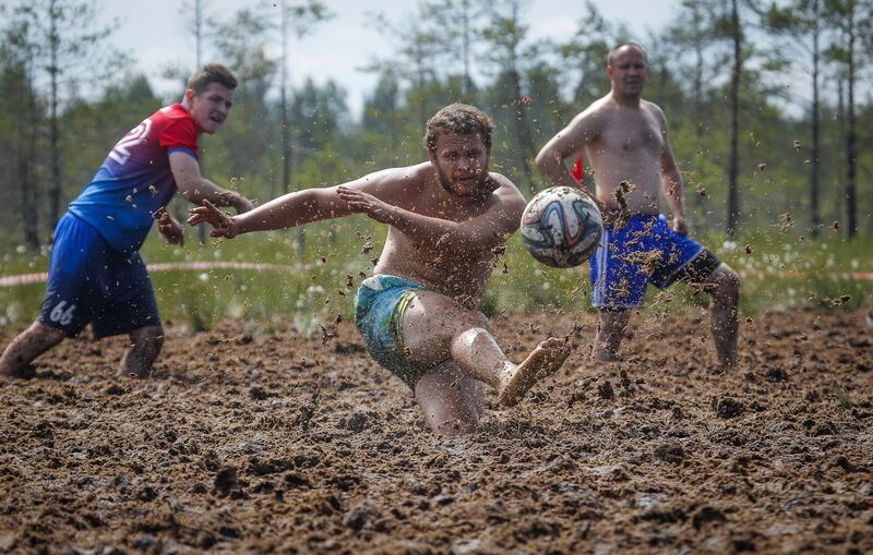 Swamp football players fight for the ball during a swamp football tournament in Pogy village, 60km south of St Petersburg, Russia.  AP
