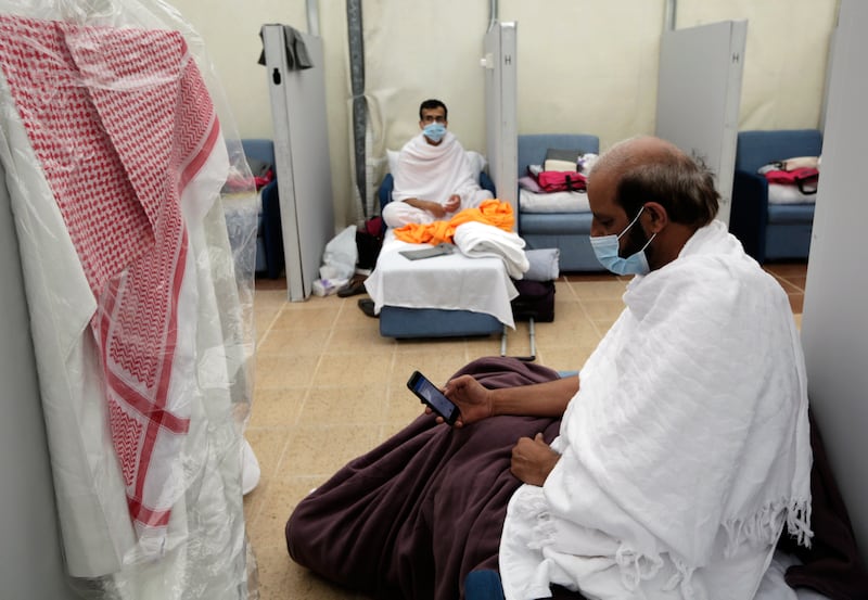 Saudi pilgrim Irak al Dofairy, 65, reads the Quran on his mobile phone at a camp in Mina.