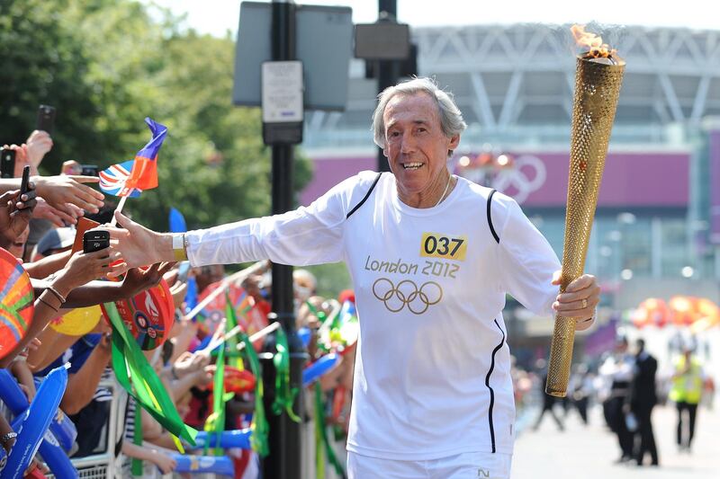 LONDON, UNITED KINGDOM - JULY 25:  In this handout image provided by LOCOG, Former World Cup winning footballer Gordon Banks carries the Olympic Flame along Wembley Way, at Wembley Stadium during Day 68 of the London 2012 Olympic Torch Relay on July 25, 2012 in London, England. The Olympic Flame is now on Day 68 of a 70-day relay involving 8,000 torchbearers covering 8,000 miles.  (Photo by LOCOG via Getty Images)