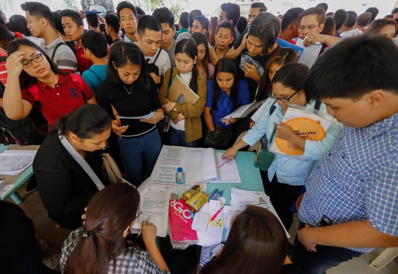 epa06703425 Filipinos gather around a recruitment booth during a job fair at the Quezon City Hall, east of Manila, Philippines, 01 May 2018. The city government held the job fair to give applicants opportunities to land jobs in various industries, as part of programs to mark International Labor Day.  EPA/ROLEX DELA PENA