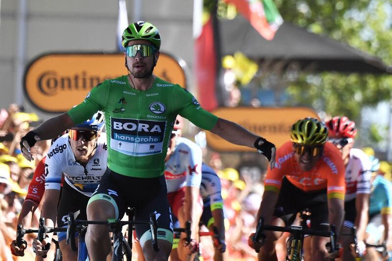 Slovakia's Peter Sagan (L), wearing the best sprinter's green jersey celebrates wearing the best young's white jersey (L), as he wins on the finish line of the fifth stage of the 106th edition of the Tour de France cycling race between Saint-Die-des-Vosges and Colmar, eastern France, in Colmar on July 10, 2019.  / AFP / JEFF PACHOUD
