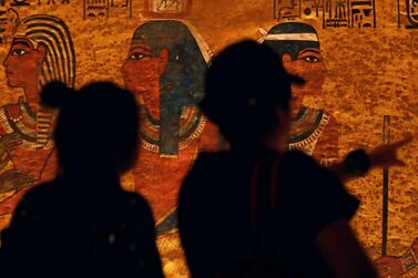 Visitors look at drawings on the wall of King Tutankhamun's tomb in Luxor, Egypt. Artefacts associated with the boy pharaoh are draw worldwide interest. Reuters