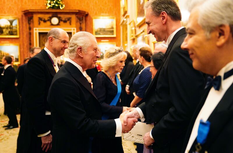 King Charles greets guests to Buckingham Palace. Getty