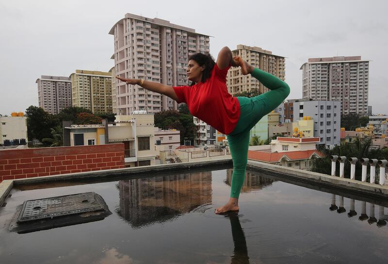 A yoga enthusiast practices yoga on a rooftop in Bangalore, India. EPA