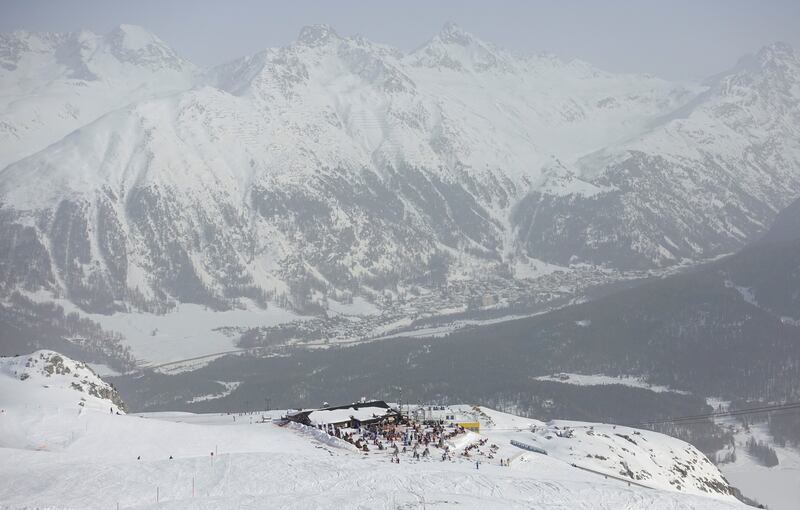 Sahara dust makes the sky misty as skiers rest on the terrace of a restaurant beside a piste at the Corviglia ski area in the Alpine resort of St. Moritz, Switzerland. Reuters