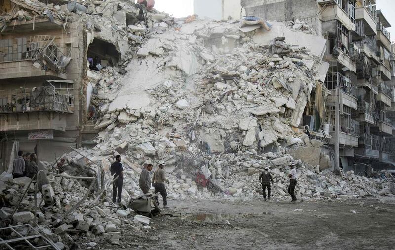 Members of Syria’s White Helmets search for victims amid the rubble of a destroyed buildings following air strikes in the rebel-held Qatarji neighbourhood of Aleppo. Karam Al Masri / AFP Photo