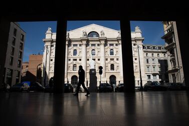 A pedestrian passes Italy's Stock Exchange, the Borsa Italiana, in Milan. The addition of the Milan bourse would mean Euronext will handle a quarter of all equity trading in Europe. Bloomberg
