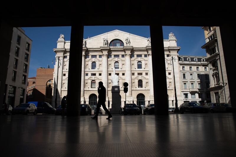 A pedestrian passes Italy's Stock Exchange, the Borsa Italiana, which is part of the London Stock Exchange Group Plc, in Milan Italy, on Thursday, Oct. 8, 2020. London Stock Exchange Group Plc is nearing the sale of Borsa Italiana to Euronext NV and two Italian institutions for about 4.5 billion euros ($5.3 billion) including debt, according to people familiar with the transaction. Photographer: Camilla Cerea/Bloomberg