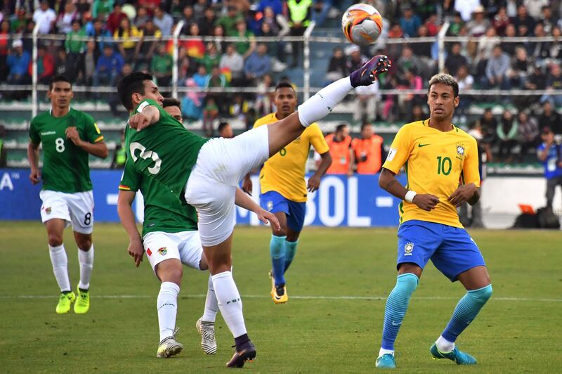 Bolivia's Gabriel Valverde attempts to control the ball ahead of Neymar. Nelson Almeida / AFP