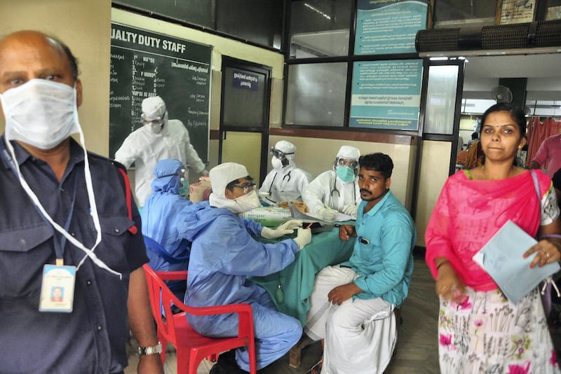 Medics wearing protective gear examine a patient at a hospital in Kozhikode in the southern state of Kerala, India May 21, 2018. Picture taken May 21, 2018. REUTERS/Stringer