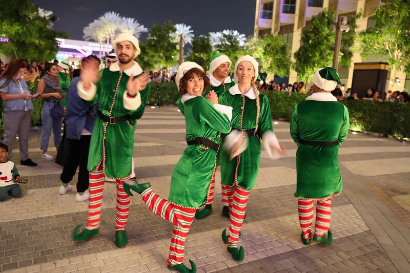 Santa's helpers show up for the tree-lighting event. Pawan Singh / The National