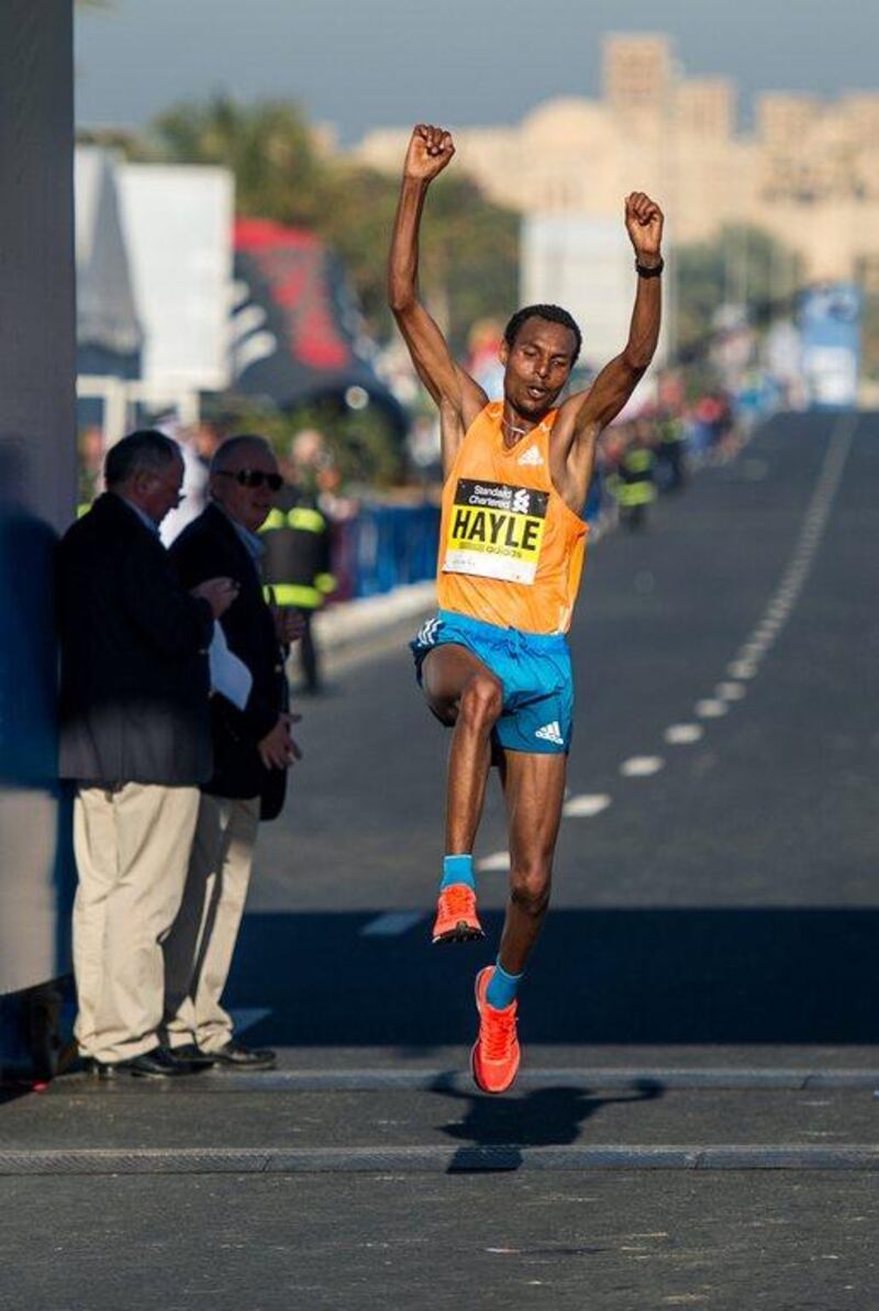 Lemi Berhanu Hayle of Ethiopia celebrates after crossing the finish line and winning the Dubai Marathon on Friday. Stephen Hindley / AP