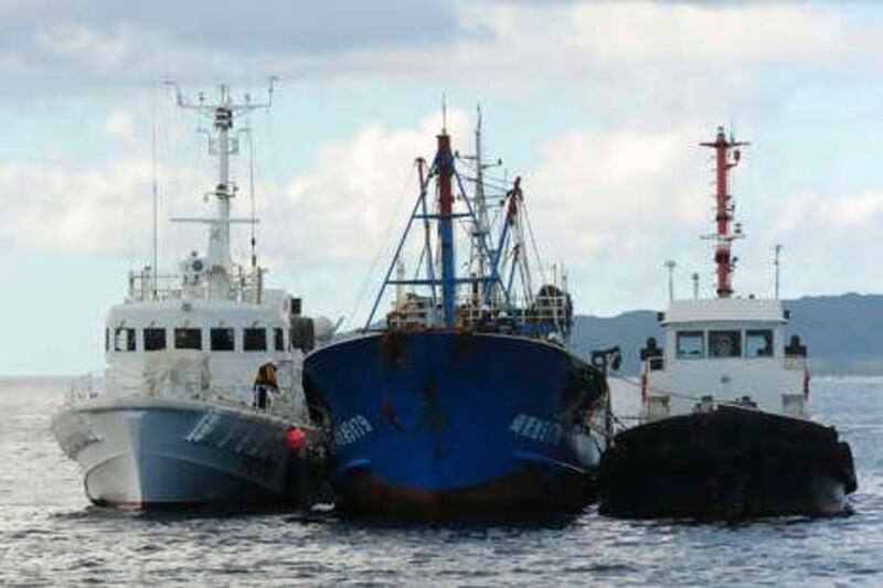 In this photo released by China's Xinhua News Agency, a detained Chinese fishing trawler is flanked by two Japanese Coast Guard vessels during an investigation by Japanese authorities near Ishigaki Island in Okinawa Prefecture of Japan, Sunday, Sept. 12, 2010. China's top foreign policy official increased pressure on Japan on Sunday by summoning its ambassador to again demand the immediate release of the Chinese fishermen and their boat detained near disputed islands.  (AP Photo/Xinhua, Ji Chunpeng) ** NO SALES ** 