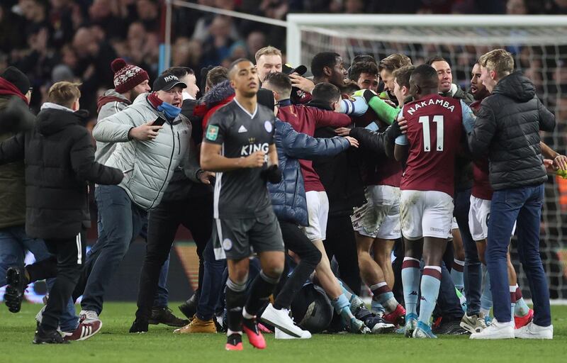 Leicester City's Youri Tielemans walks past Aston Villa fans and players in celebration. Reuters