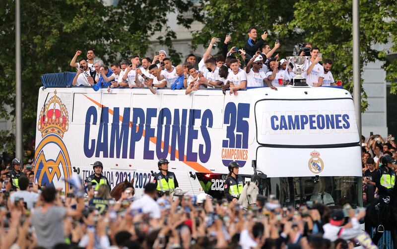 Real Madrid players celebrate winning La Liga on top of the bus with fans at Cibeles fountain in Madrid. Reuters