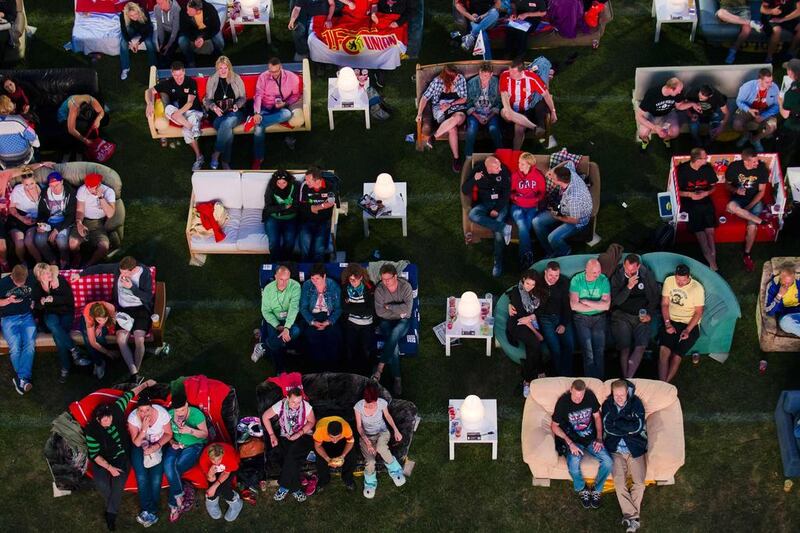 People sit on sofas as they watch the opening game of the 2014 World Cup at the Alte Forsterei in Berlin, Germany. Thomas Peter / Reuters