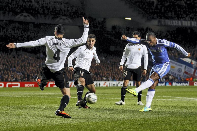Chelsea's Didier Drogba (R) shoots to score against Valencia during their Champions League Group E soccer match at Stamford Bridge in London December 6, 2011. REUTERS/Eddie Keogh (BRITAIN - Tags: SPORT SOCCER)