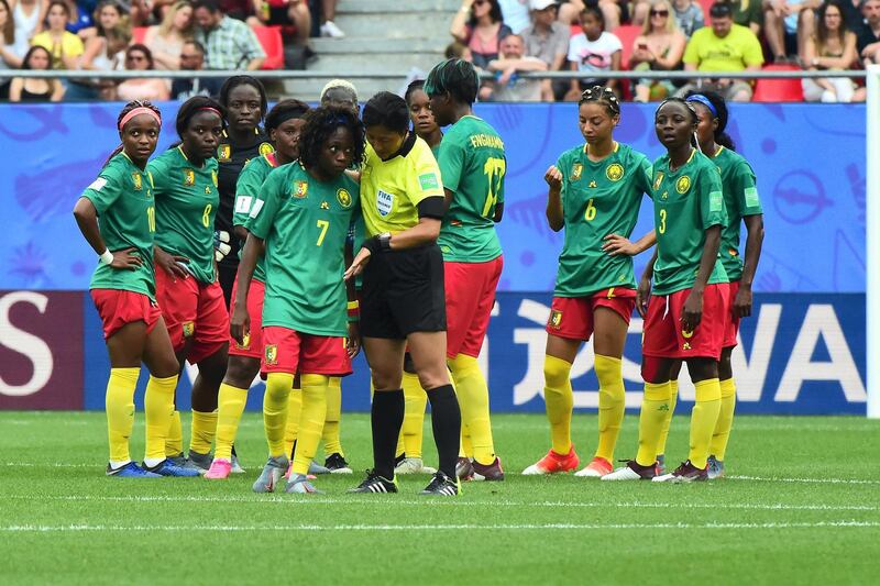 VALENCIENNES, FRANCE - JUNE 23:  (C) Gabrielle Aboudi Onguene of Cameroon speaks with Referee Qin Liang during the 2019 FIFA Women's World Cup France Round Of 16 match between England and Cameroon at Stade du Hainaut on June 23, 2019 in Valenciennes, France.  (Photo by Pier Marco Tacca/Getty Images)