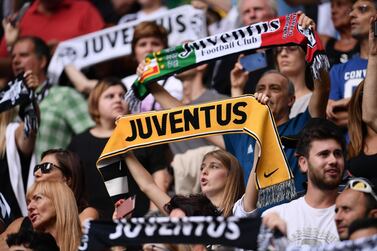 (FILES) In this file photo taken on September 16, 2018 Juventus fans cheer during the Italian Serie A football match Juventus vs Sassuolo at the Juventus stadium in Turin. Plans for a breakaway Super League announced by twelve of European football's most powerful clubs plunged European football into an unprecedented crisis on April 19, 2021, with threats of legal action and possible bans for players. Six Premier League teams -- Liverpool, Manchester United, Arsenal, Chelsea, Manchester City and Tottenham Hotspur -- joined forces with Spanish giants Real Madrid, Barcelona and Atletico Madrid and Italian trio Juventus, Inter Milan and AC Milan to launch the planned competition. / AFP / Marco BERTORELLO