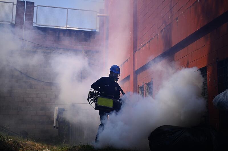 A municipal worker disinfects a quarantined homeless shelter in El Salvador's capital San Salvador.  AFP