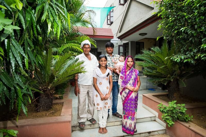 30th July, 2013, Gurgaon, Haryana, India. Vasundhra Yadav (14, front centre) with L-R: her father Ashok Singh Yadav (45) her brother Ravi Singh Yadav (25) holding his 4 month old daughter Sandhiya and sister-in-law Pinky (24) at Harmony House, Sector 17a, Gurgaon, Haryana, India on the 30th July, 2013. 

Vasundrha is one of the under -privileged children benefitting from the Harmony House

Harmony House is a charity run by a British Expat living in Dubai that caters to underprivileged children in the slums of Gurgaon. It provides shelter, education and recreation for them and works closely with local schools to set up an academic curriculum. It also holds vocational courses for older children and workshops on key social issues.

PHOTOGRAPH BY AND COPYRIGHT OF SIMON DE TREY-WHITE

+ 91 98103 99809
+ 91 11 435 06980
+44 07966 405896
+44 1963 220 745
email: simon@simondetreywhite.com *** Local Caption ***  Harmony House 300713_061.JPG