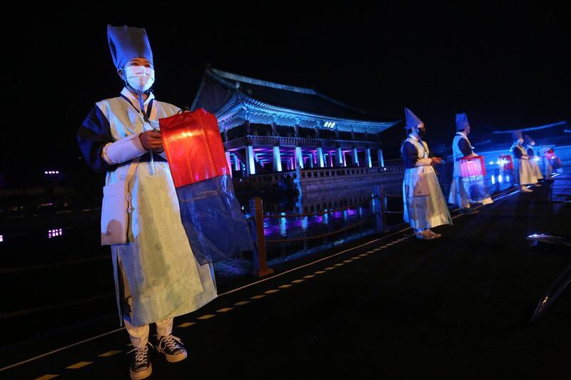 Performers wearing face masks hold lanterns during the Royal Culture Festival at the Gyeongbok Palace in Seoul, South Korea. A month-long heritage festival that explores South Korea's royal palaces and culture started on October 10, with some of this year's events scheduled to be held online amid the coronavirus pandemic. AP Photo