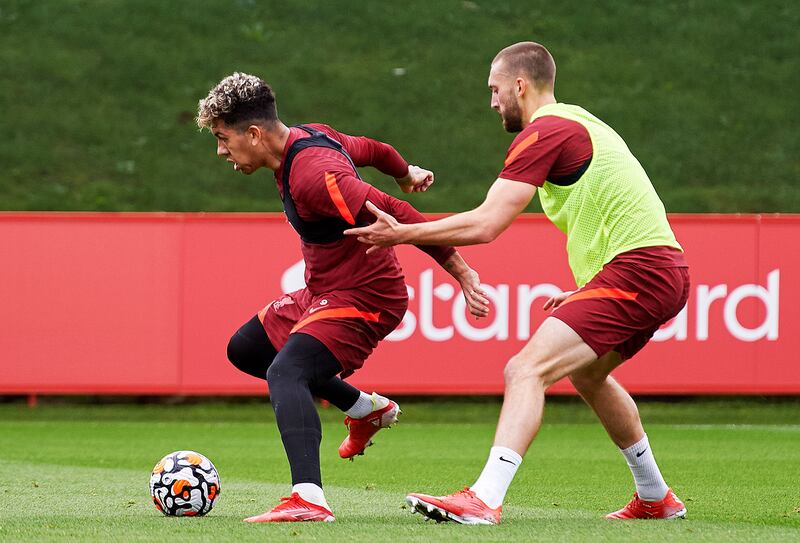 Roberto Firmino and Nathaniel Phillips of Liverpool during a training session at AXA Training Centre. All photos by Getty Images