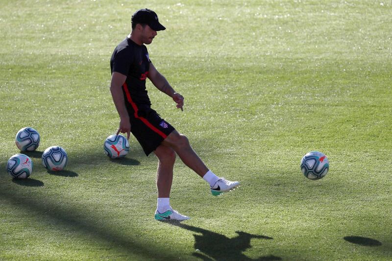 Atletico manager Diego Simeone kicks a ball.