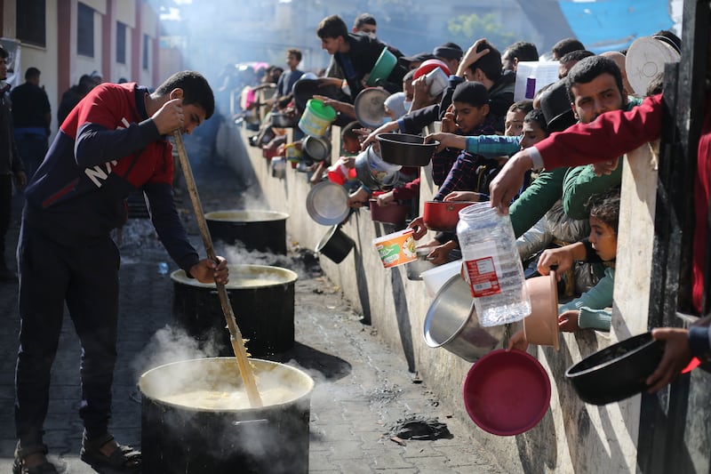 Palestinians queue for food in Rafah, the Gaza Strip, on December  20, 2023.  AP Photo