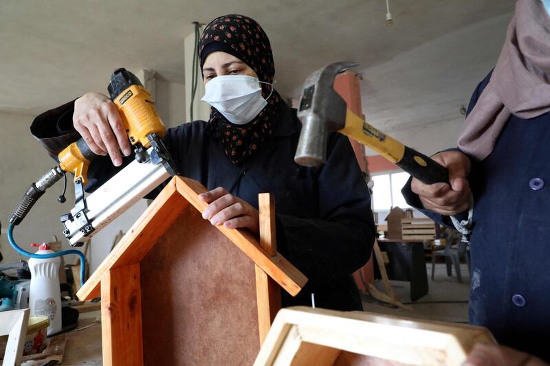 A Palestinian woman works at a carpenter workshop, established and run by a group of women, in the village of Al Walajeh near the West bank town of Bethlehem. AFP