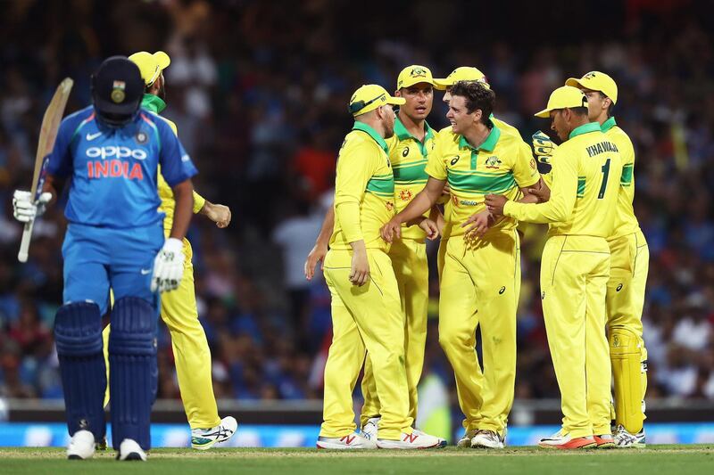 SYDNEY, AUSTRALIA - JANUARY 12: Jhye Richardson of Australia celebrates with team mates after taking the wicket of Dinesh Karthik of India during game one of the One Day International series between Australia and India at Sydney Cricket Ground on January 12, 2019 in Sydney, Australia. (Photo by Matt King/Getty Images)