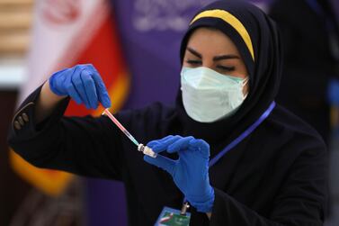 A medic in Tehran prepares a COVIran Barekat Covid-19 vaccine to administer to volunteers during the third phase of the clinical trial of the Iranian-developed vaccine. AP