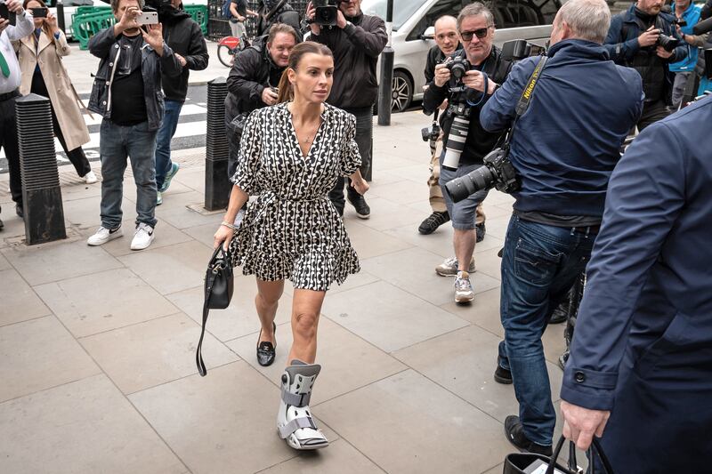 Coleen Rooney is followed by photographers as she arrives at court on the second day of the trial. PA