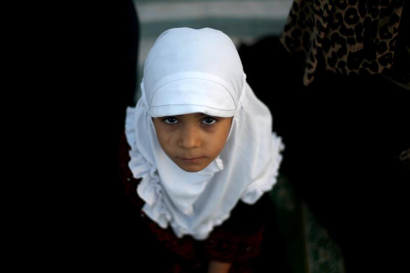 A Palestinian girl attends Eid al-Fitr prayers in Gaza City June 25, 2017. REUTERS/Ibraheem Abu Mustafa