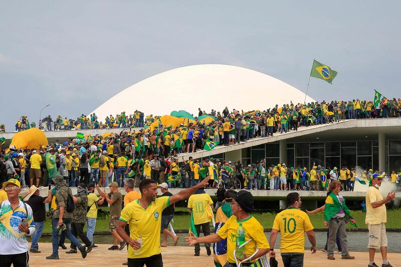 Startling images on social media showed a tide of people storming the national Congress, many waving Brazilian flags. AFP