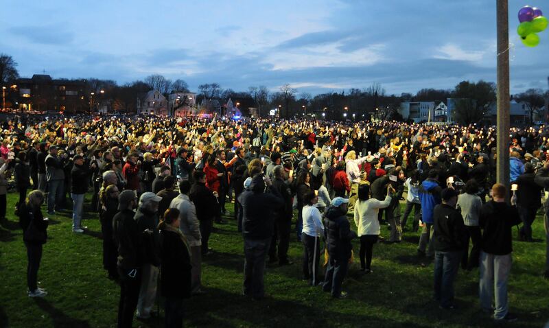 Hundreds gather for a vigil ceremony April 16, 2013 in Dorcester, Massachusetts honoring the Richard family, who's 8-year-old son Martin was killed,  sister Jane, who lost a leg, and mother Denise, who was also seriously injured when bombs exploded at the finish of the Boston Marathon April 15th.   AFP PHOTO/John MOTTERN
 *** Local Caption ***  926312-01-08.jpg