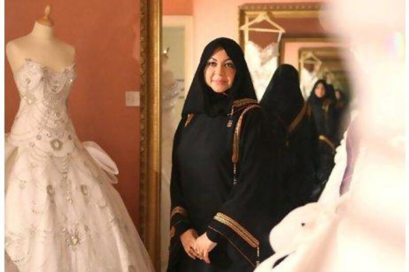 Mona Al Mansouri, the designer and owner of Al Mansouri Fashion, among some of her creations.