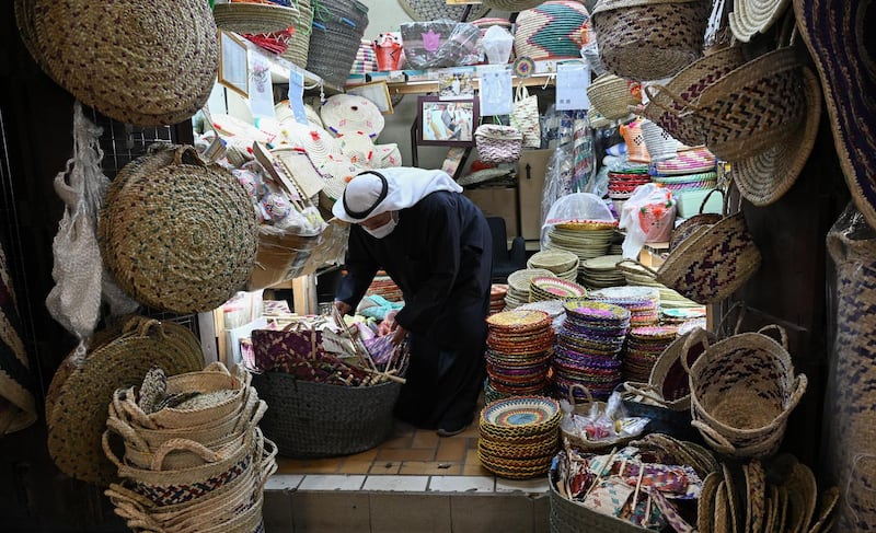 A vendor selling traditional baskets sorts his stock at Kuwait City's Souk Al Mubarakiya. EPA