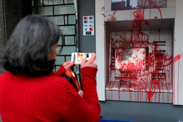 A woman photographs a vandalised ATM machine in the Lebanese capital Beirut, January 15. Anwar Amro / AFP