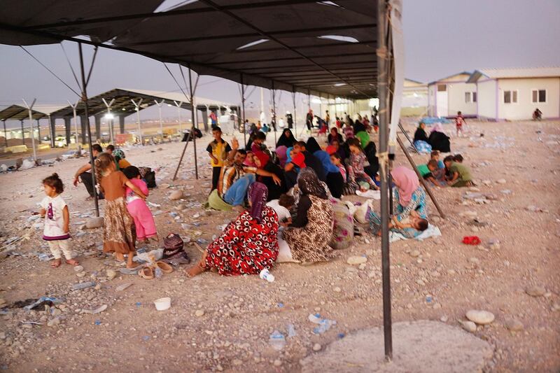 KHAZAIR, IRAQ - JULY 03: Iraqi families who fled recent fighting near the city of Mosul prepare to sleep on the ground as they try to enter a temporary displacement camp but are blocked by Kurdish soldiers on July 3, 2014 in Khazair, Iraq. The families, many with small and sick children, have no shelter and little water and food. The displacement camp Khazair is now home to an estimated 1,500 internally displaced persons (IDP's) with the number rising daily. Tens of thousands of people have fled Iraq's second largest city of Mosul after it was overrun by ISIS (Islamic State of Iraq and Syria) militants. Many have been temporarily housed at various IDP camps around the region including the area close to Erbil, as they hope to enter the safety of the nearby Kurdish region.  (Photo by Spencer Platt/Getty Images)