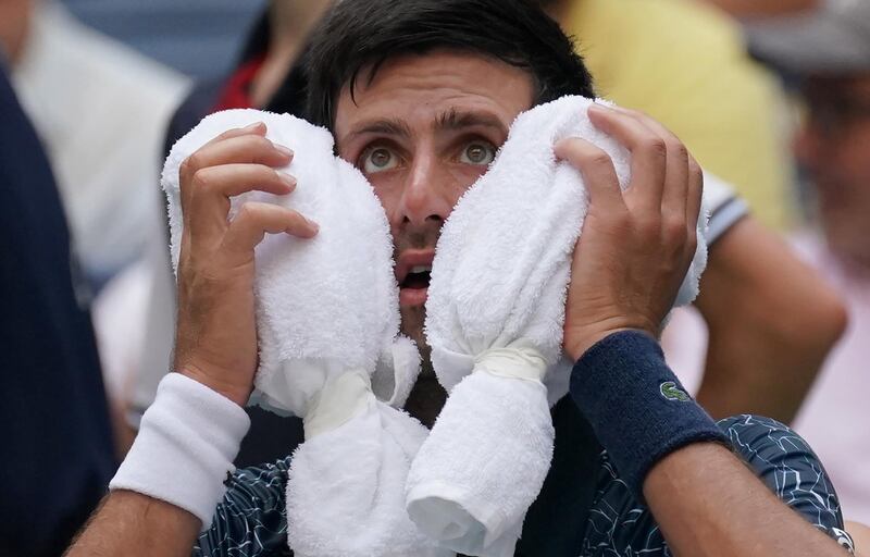 Novak Djokovic of Serbia towels off in the heat against Marton Fucsovics of Hungary during their Day 2 2018 US Open Men's Singles match at the USTA Billie Jean King National Tennis Center in New York on August 28, 2018. (Photo by TIMOTHY A. CLARY / AFP)