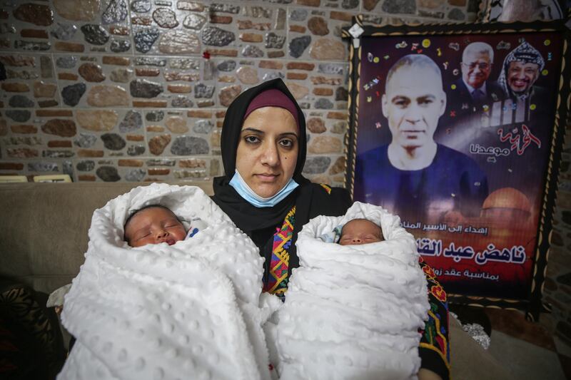 Palestinian Rasmia Hmaid with her twins Hani and Hammam at their family home in Gaza City. Photo: Majd Mohamad for The National