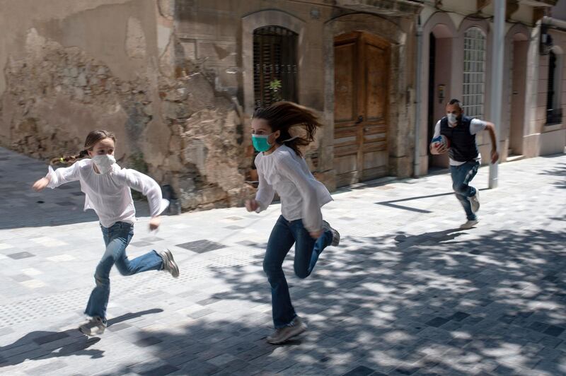 Joan, 45, chases his daughters Ines, 11, and Mar, 9, as they play in the street in Barcelona, during a national lockdown to prevent the spread of the COVID-19 disease. After six weeks stuck at home, Spain's children were being allowed out today to run, play or go for a walk as the government eased one of the world's toughest coronavirus lockdowns. Spain is one of the hardest hit countries, with a death toll running a more than 23,000 to put it behind only the United States and Italy despite stringent restrictions imposed from March 14, including keeping all children indoors. Today, with their scooters, tricycles or in prams, the children accompanied by their parents came out onto largely deserted streets. AFP