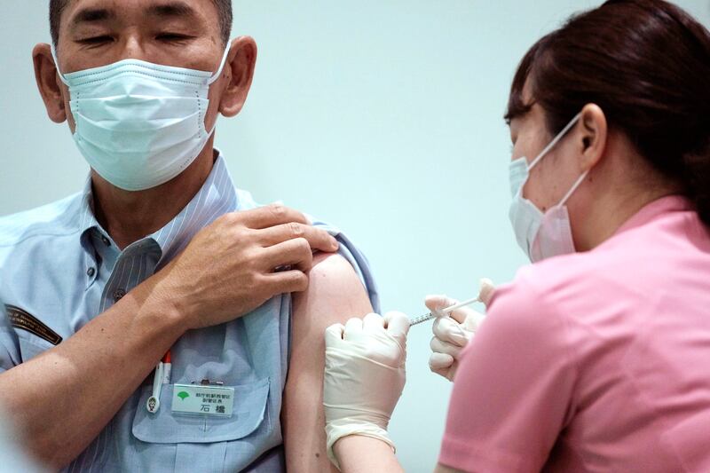 A Tokyo Metropolitan Government employee receives a Moderna coronavirus vaccine shot at a new vaccination centre in Tokyo. The inoculation drive is part of government efforts to increase vaccinations before the Tokyo 2020 Olympic Games begin.